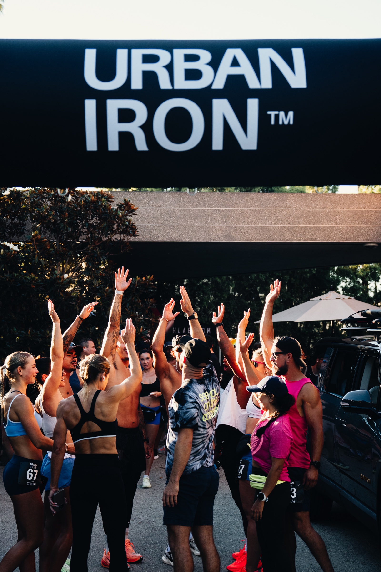Urban Iron athletes gathering beneath the event banner